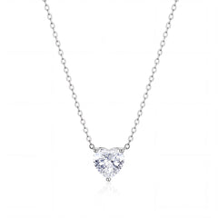 A heart-shaped diamond pendant necklace in a solitaire setting on a delicate silver chain, presented on a clean white background with a subtle reflection.