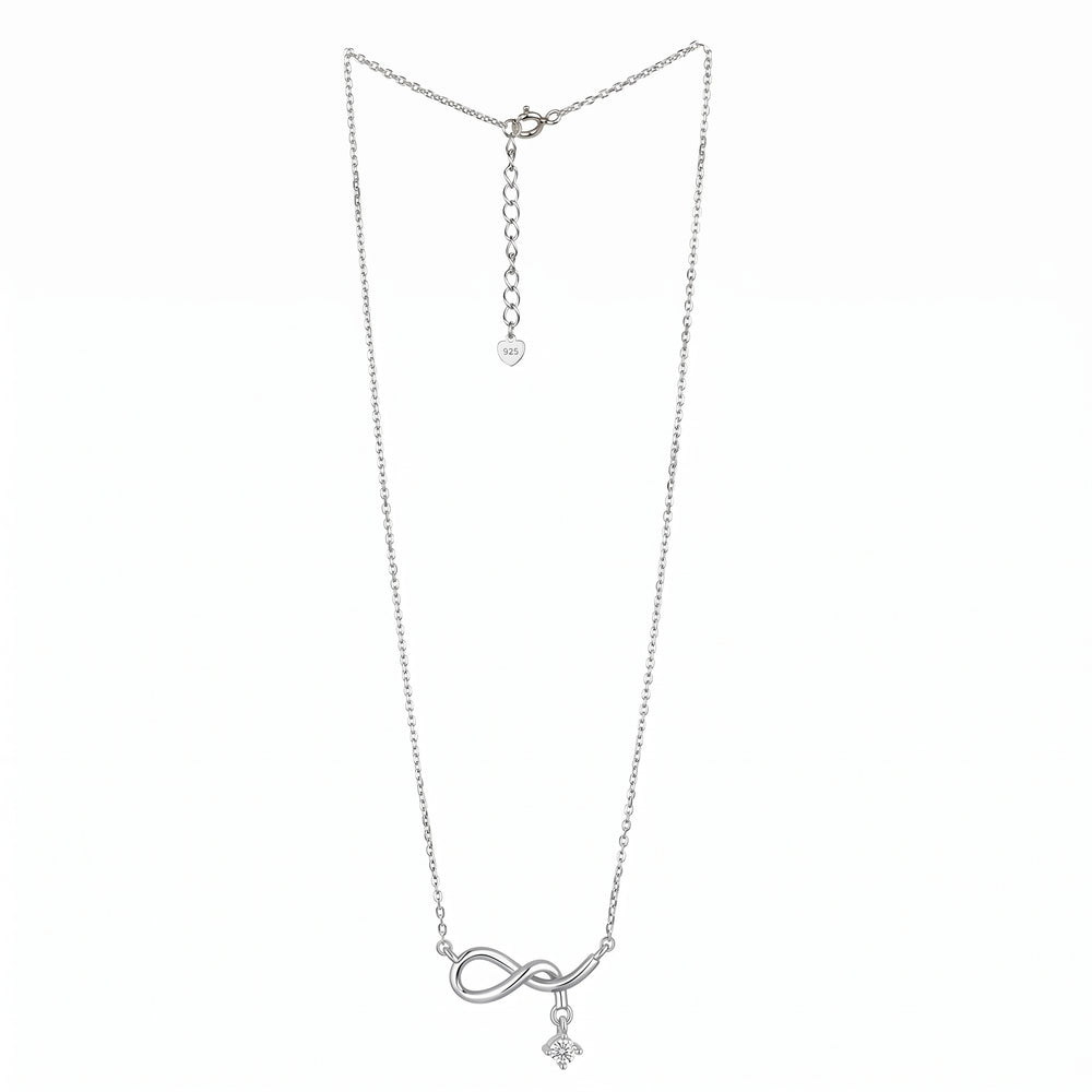 A delicate silver chain necklace featuring an infinity symbol pendant with a small cross charm hanging below, displayed against a solid white background infinity drop necklace.