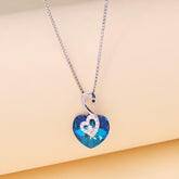 Necklace with a blue heart-shaped pendant on a beige background