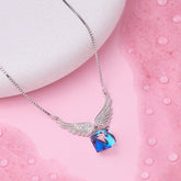 925 Silver Necklace with a blue and pink pendant on a pink surface