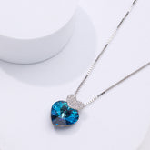 pure silver Necklace with a blue heart-shaped crystal pendant on a white background
