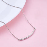 Silver necklace with a curved pendant on a pink background 925 silver jewellery for women