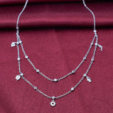 925 silver Silver necklace with floral charms on a red fabric background