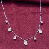 925 silver Necklace with square-shaped gemstones on a red fabric.