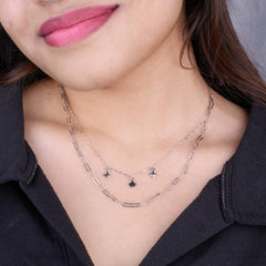 Close-up of a person wearing a silver necklace with star pendants 925 Silver pendant for women.