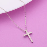 925 Silver cross necklace on a pink background