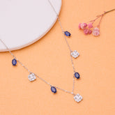 925 Silver Necklace with blue gemstones and clear crystals on an orange background