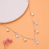 925 Silver Necklace with diamond pendants on an orange surface