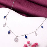 925 silver Necklace with blue gemstones and a diamond pendant on a white surface with a purple fabric background