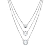 Three silver necklaces with round diamond pendants for women