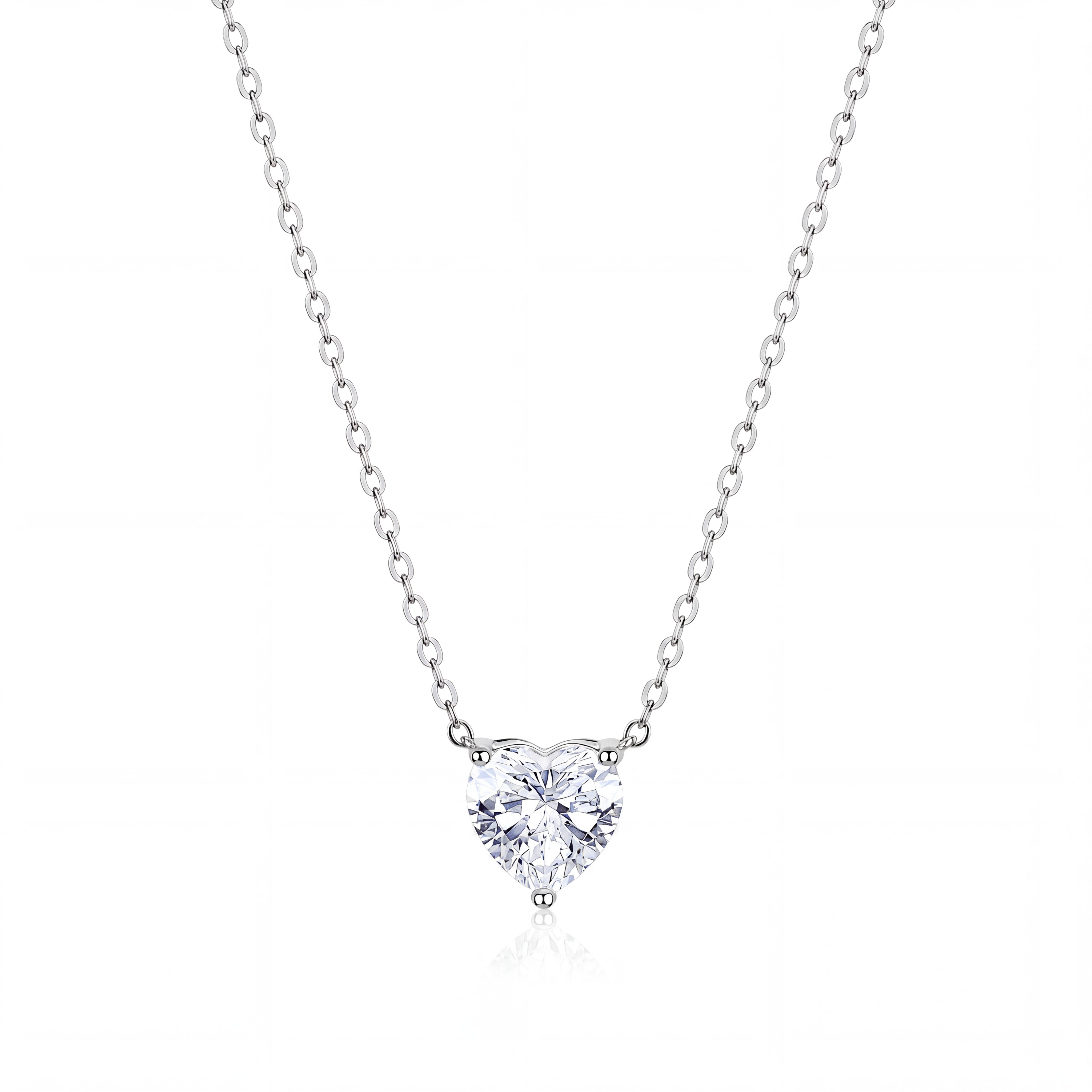 A heart-shaped diamond pendant necklace in a solitaire setting on a delicate silver chain, presented on a clean white background with a subtle reflection.
