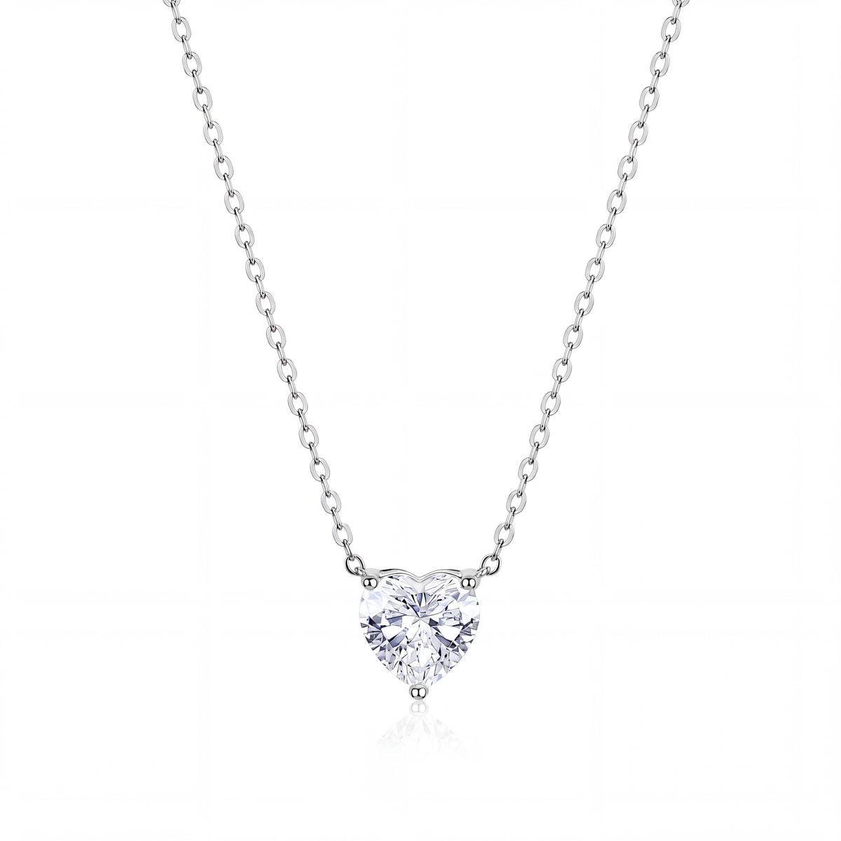 A heart-shaped diamond pendant necklace in a solitaire setting on a delicate silver chain, presented on a clean white background with a subtle reflection.