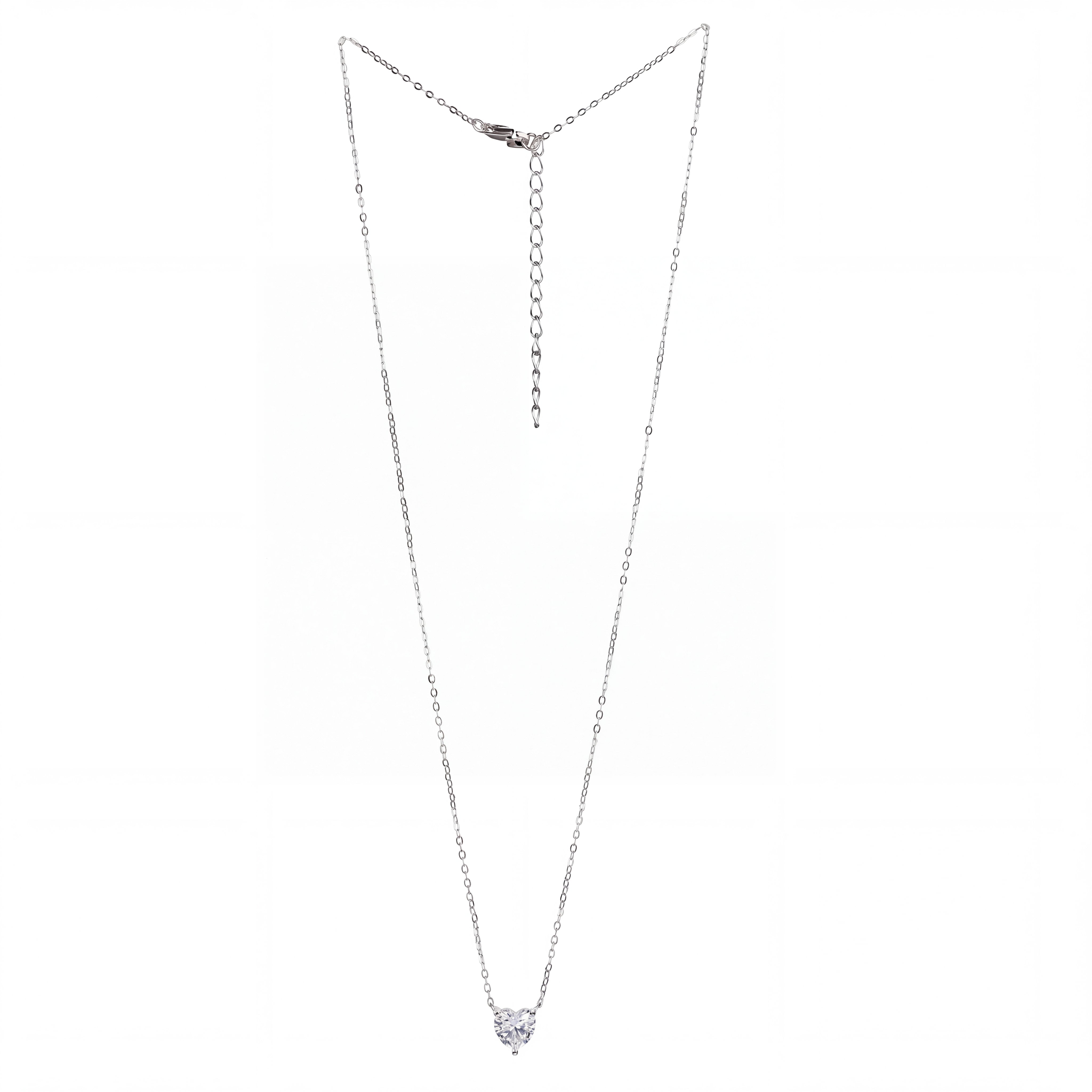 A delicate silver chain necklace with a small heart-shaped clear gemstone pendant, displayed against a plain white background.