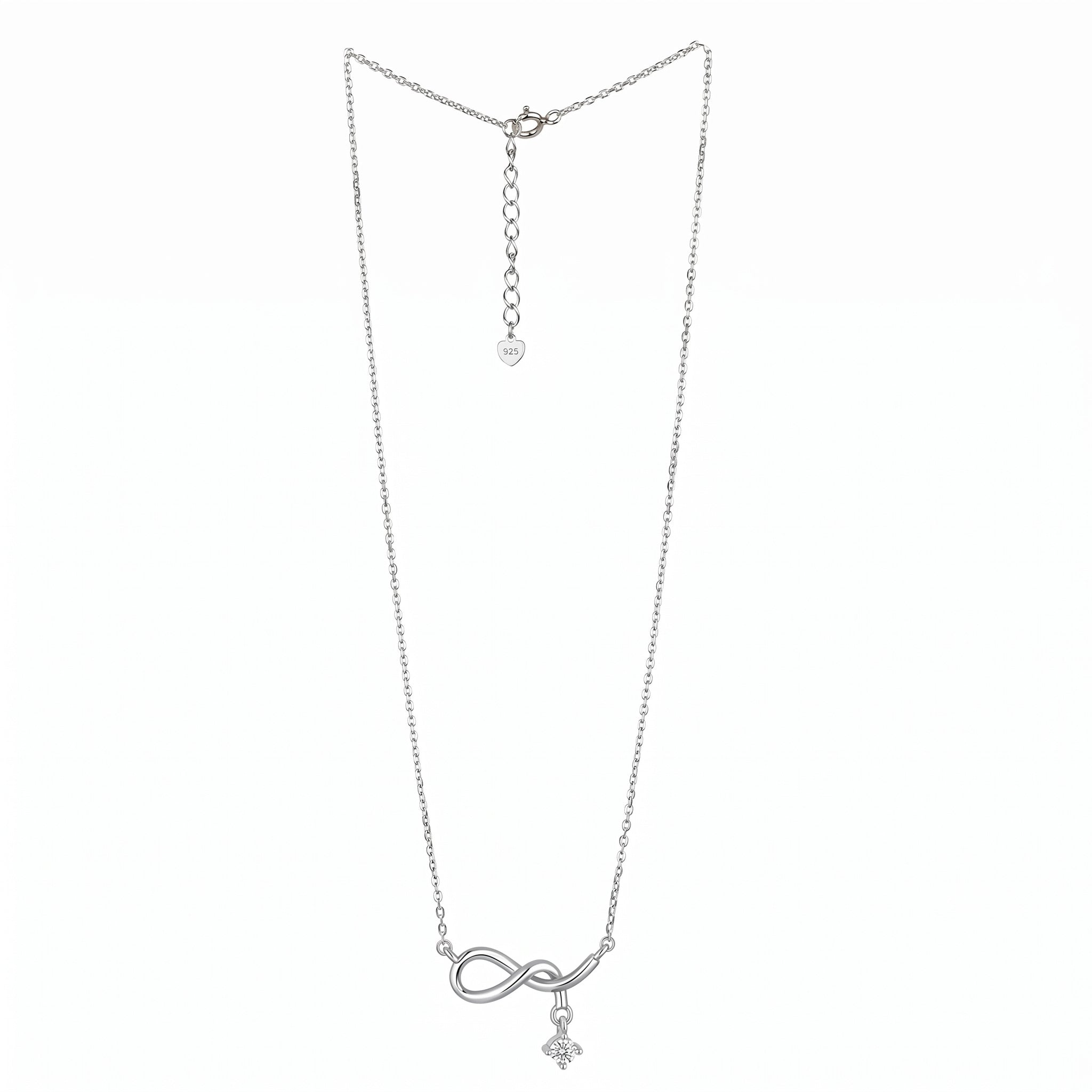 A delicate silver chain necklace featuring an infinity symbol pendant with a small cross charm hanging below, displayed against a solid white background infinity drop necklace. 