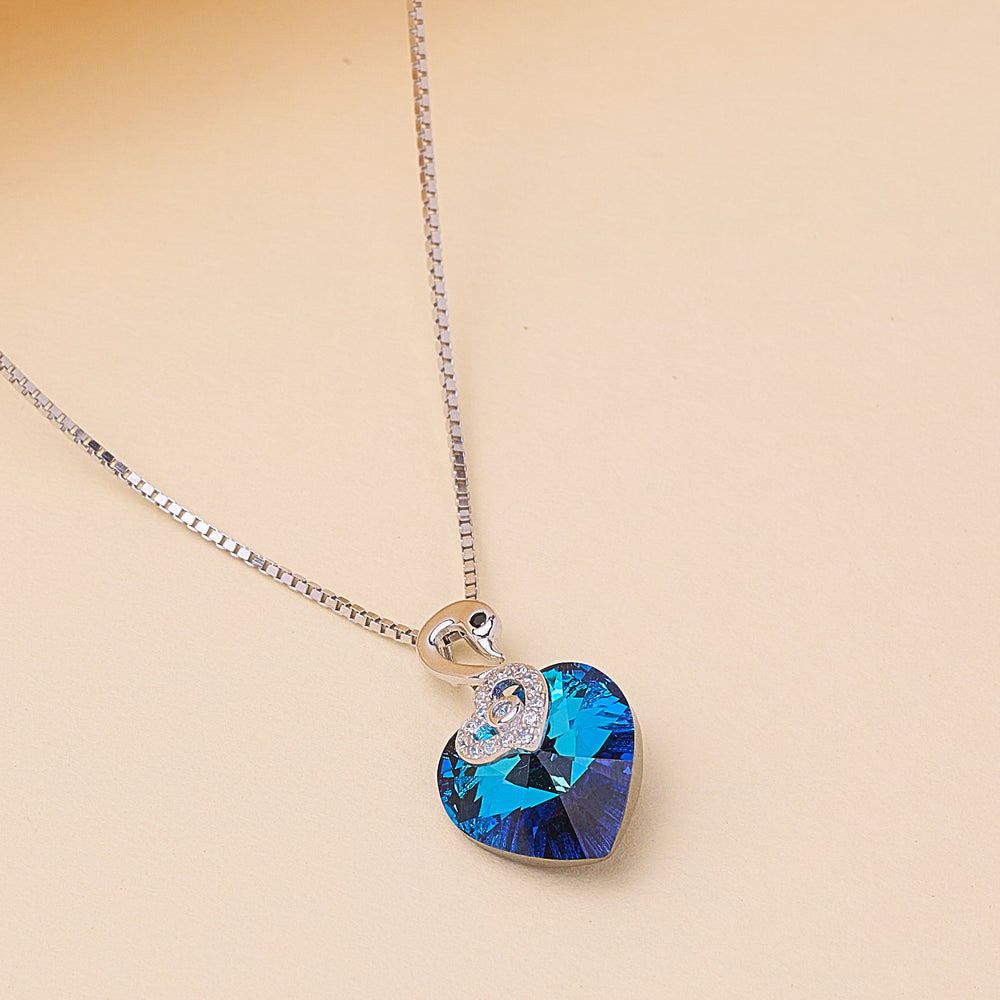 Necklace with a blue heart-shaped pendant with swan