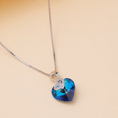 Necklace with a blue heart-shaped pendant with swan