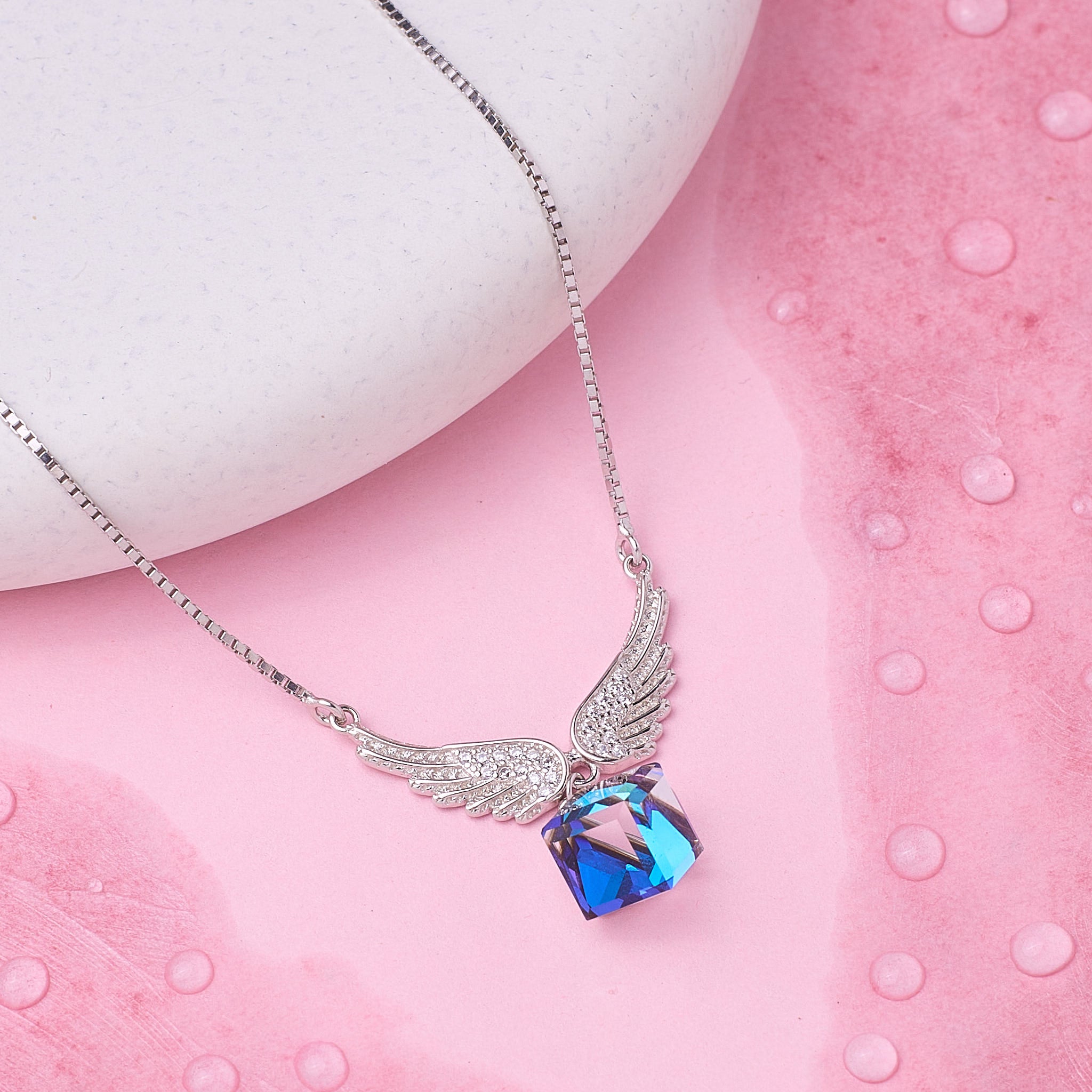 925 Silver Necklace with a blue and pink pendant on a pink surface