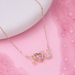 Rose gold necklace with a heart-shaped I love you pendant on a pink background 925 silver pendant for women 