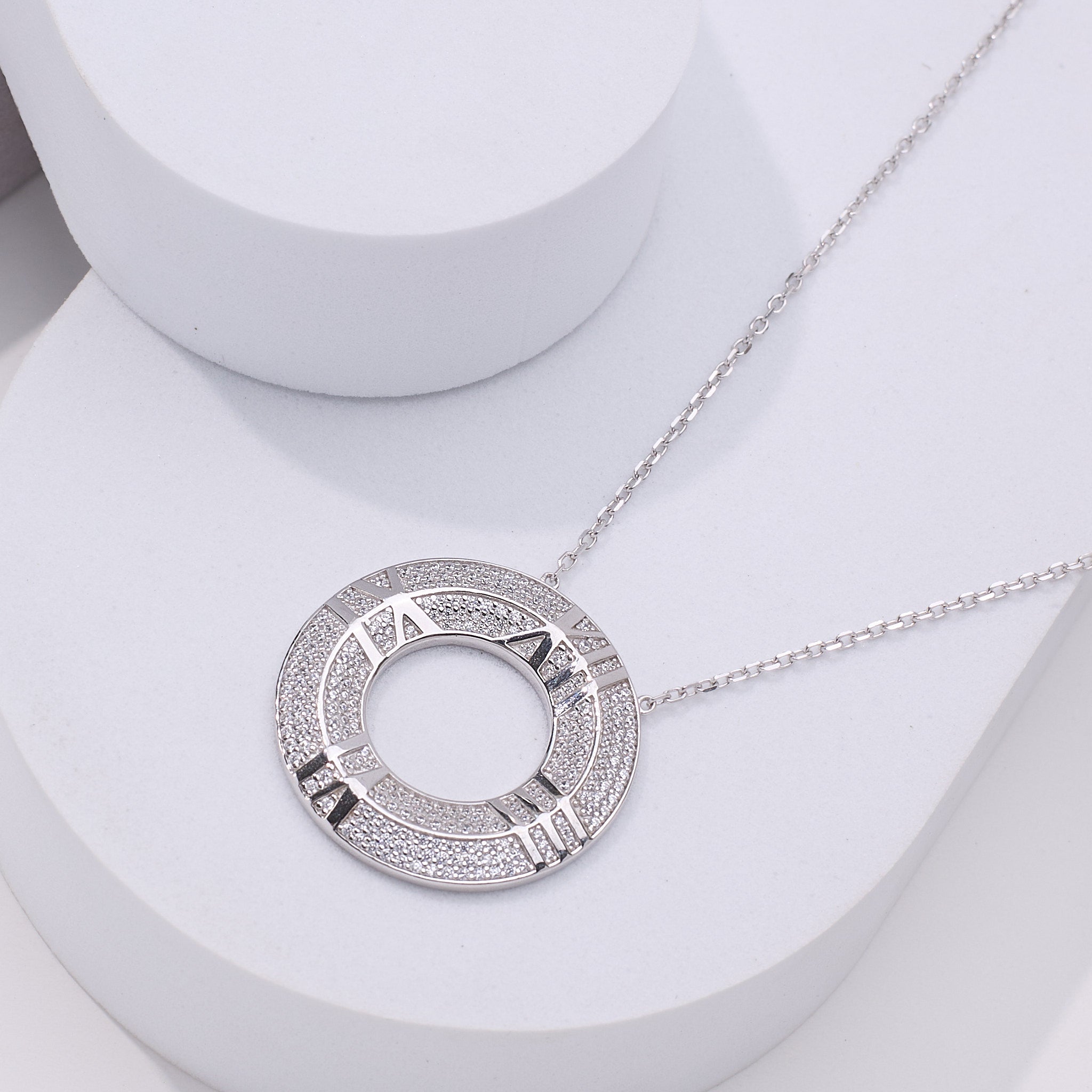 Pure 925 Silver necklace with a circular clock pendant with roman numerals on it 