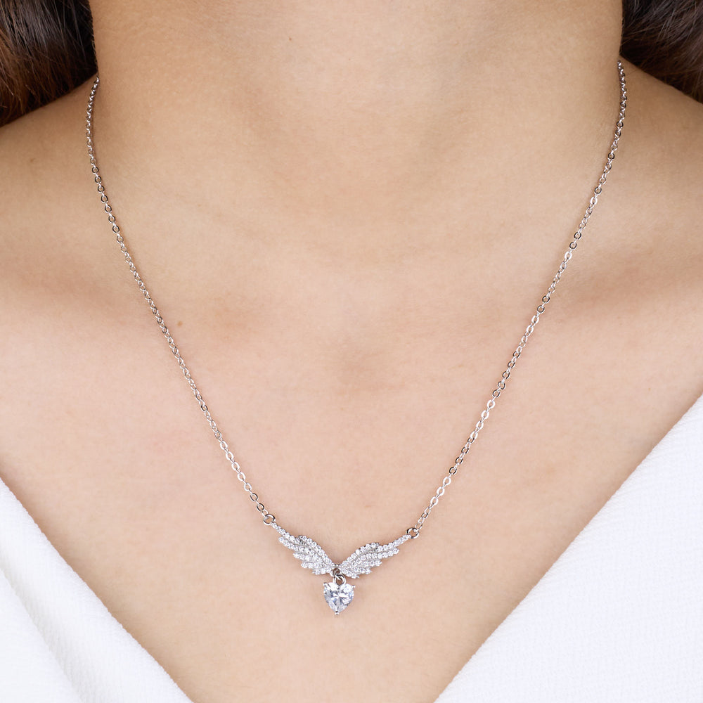pure 925 Silver necklace with a heart and wing design on a person wearing a white top.