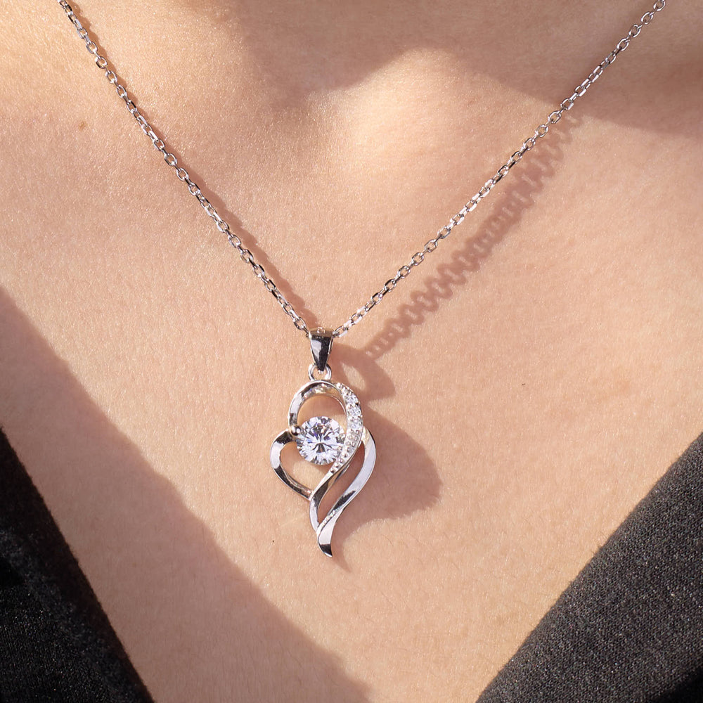 Silver necklace with a diamond pendant on a person's neck 925 silver pendant for women.