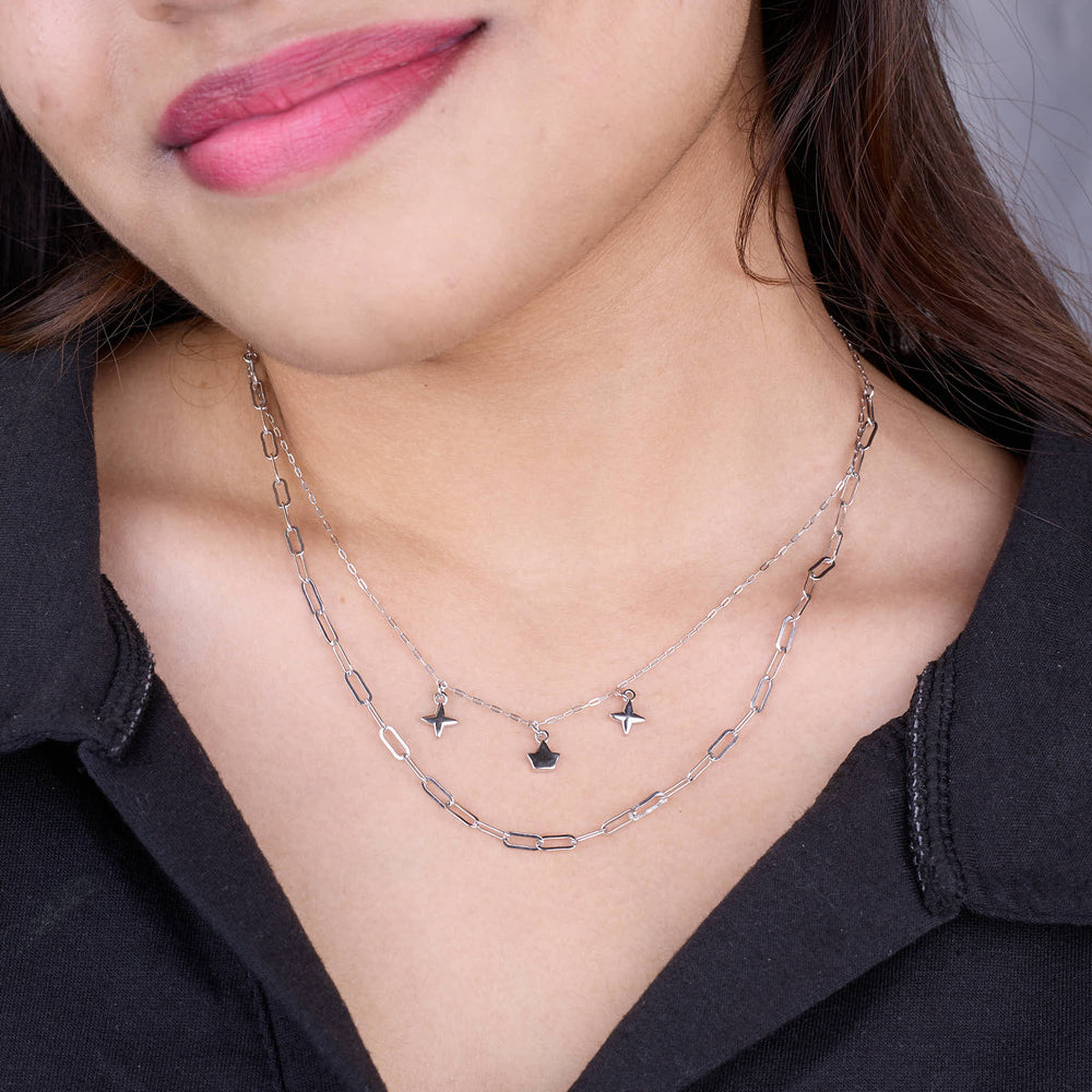 Close-up of a person wearing a silver necklace with star pendants 925 Silver pendant for women.