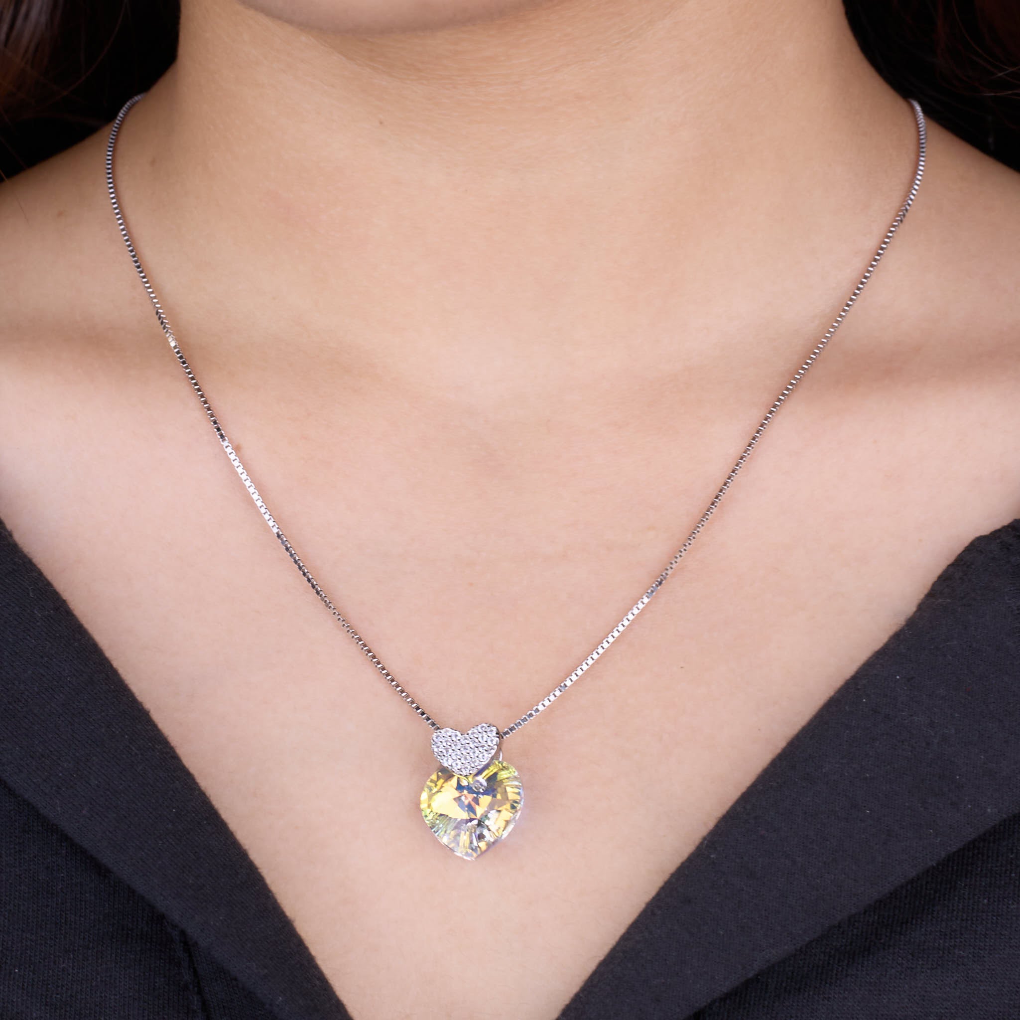 Necklace with a heart-shaped pendant worn by a person 925 silver pendant for women.
