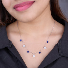 925 Silver  Necklace with blue and clear gemstones worn by a person against a neutral background