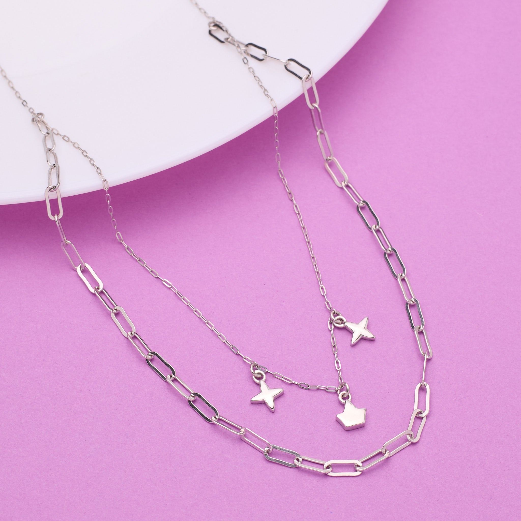 Silver chain necklace with star pendants on a pink background 925 Silver pendant for women