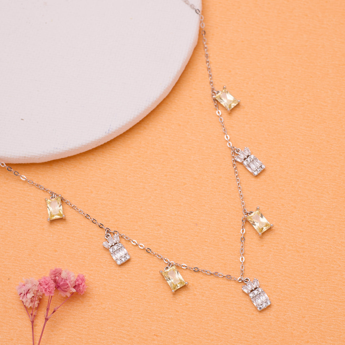 925 Silver Necklace with diamond pendants on an orange surface