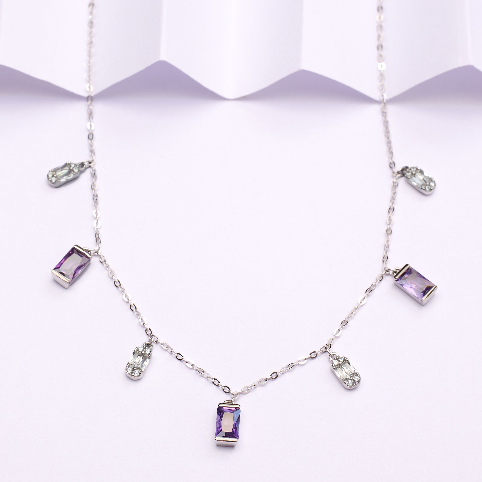 925 silverNecklace with purple gemstones on a white background