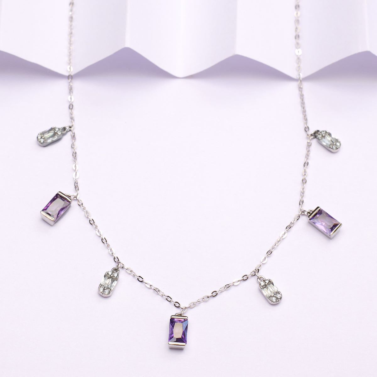 925 silverNecklace with purple gemstones on a white background